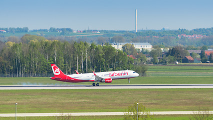 Image showing Passenger plane of Air Berlin airline touching down with smoke