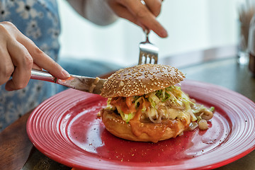 Image showing woman eating tasty grilled burger