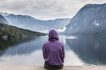 Image showing Sporty woman watching tranquil overcast morning scene at lake Bohinj, Alps mountains, Slovenia.