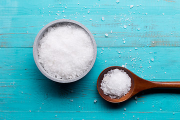 Image showing sea salt in bowl and in spoon on wooden background