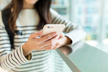 Image showing Woman checking something on cellphone