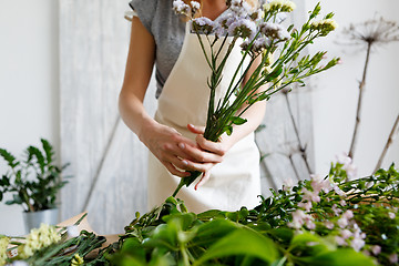 Image showing Florist at work making bouquet