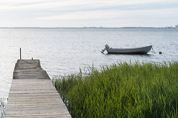 Image showing Old jetty and an anchored small boat