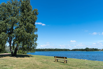 Image showing Wooden bench by seaside