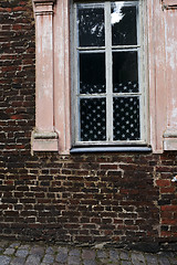 Image showing brick wall and american flag in the window