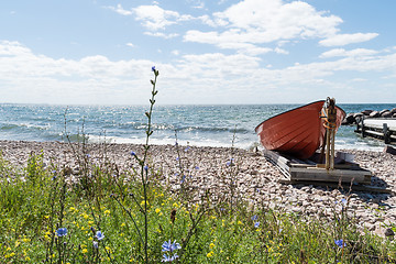 Image showing Landed red rowing boat