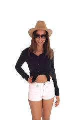Image showing Woman in shorts, hat and sunglasses.