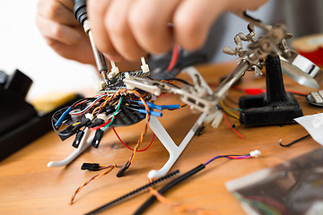 Image showing Man installing the accessories on drone body