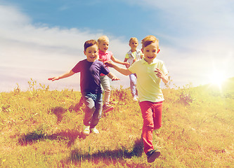 Image showing group of happy kids running outdoors