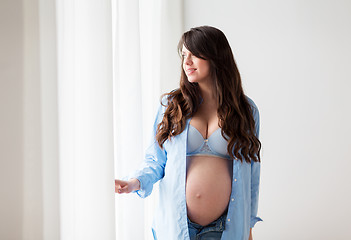 Image showing happy pregnant woman with big tummy at home