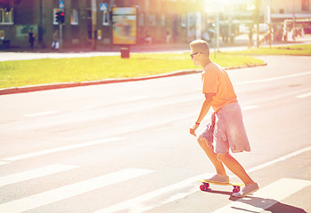 Image showing teenage boy on skateboard crossing city crosswalk