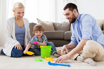 Image showing happy family playing with beach toys at home