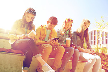 Image showing teenage friends with smartphone and coffee cups