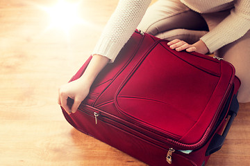 Image showing close up of woman packing travel bag for vacation