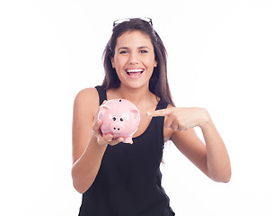 Image showing Young woman with glasses happy with piggy bank