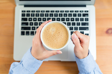 Image showing Woman drink of coffee with laptop computer