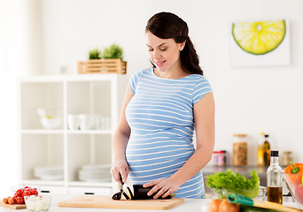 Image showing pregnant woman cooking vegetables at home