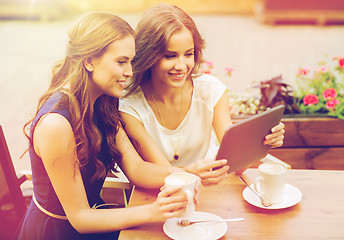 Image showing young women with tablet pc and coffee at cafe