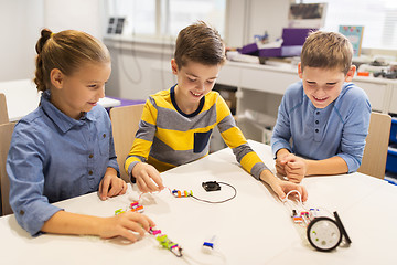 Image showing happy children building robots at robotics school