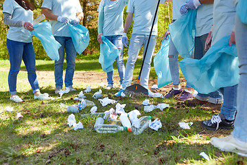 Image showing volunteers with garbage bags cleaning park area