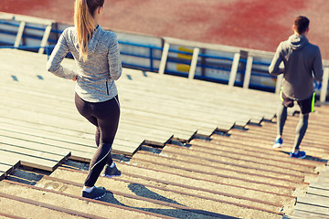 Image showing close up of couple running downstairs on stadium