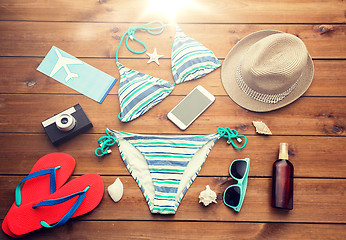 Image showing close up of smartphone and beach stuff