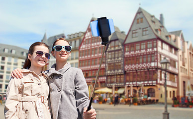 Image showing girls with smartphone selfie stick in frankfurt