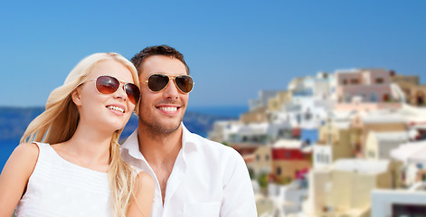 Image showing happy couple in sunglasses over santorini island