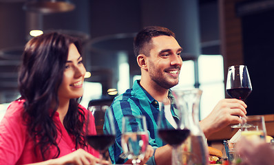 Image showing friends clinking glasses of wine at restaurant