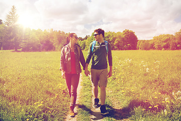 Image showing happy couple with backpacks hiking outdoors