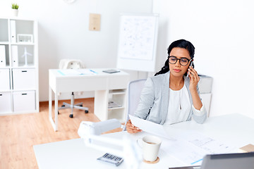 Image showing businesswoman calling on smartphone at office