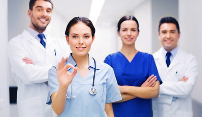 Image showing group of medics at hospital showing ok hand sign