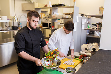 Image showing chef and cook cooking food at restaurant kitchen