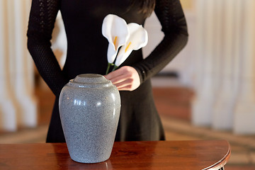 Image showing woman with cremation urn at funeral in church