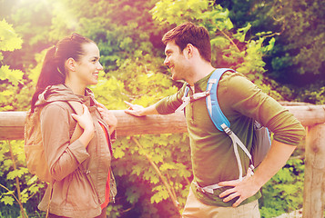 Image showing smiling couple with backpacks in nature