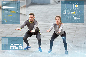 Image showing couple doing squats and exercising outdoors