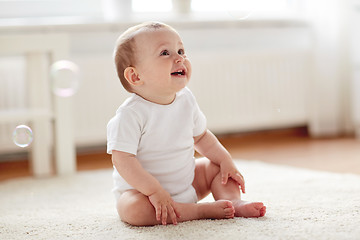 Image showing happy baby with soap bubbles at home