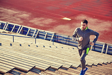 Image showing young man running upstairs on stadium