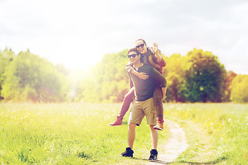 Image showing happy couple with backpacks having fun outdoors