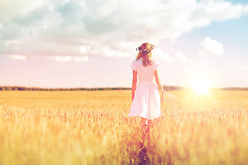 Image showing happy young woman in flower wreath on cereal field