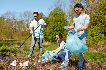 Image showing volunteers with garbage bags cleaning park area