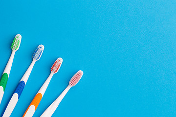 Image showing Four toothbrushes nd, place for words