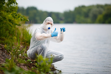 Image showing Ecologist in respirator with bulb