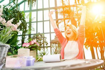 Image showing Photo of happy flowers seller.