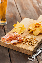 Image showing Beer glass and potato chips, pistachios isolated on a white