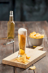 Image showing Beer glass and potato chips, pistachios isolated on a white