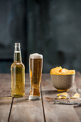 Image showing Beer glass and potato chips, pistachios isolated on a white