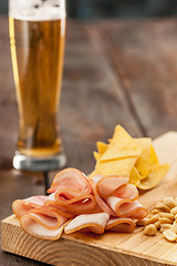 Image showing Beer glass and potato chips, pistachios isolated on a white