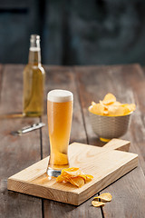 Image showing Beer glass and potato chips, pistachios isolated on a white