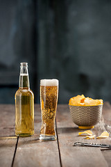 Image showing Beer glass and potato chips, pistachios isolated on a white